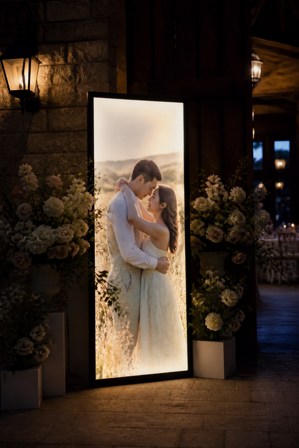 Glowing engagement photo with florals at a venue entryway